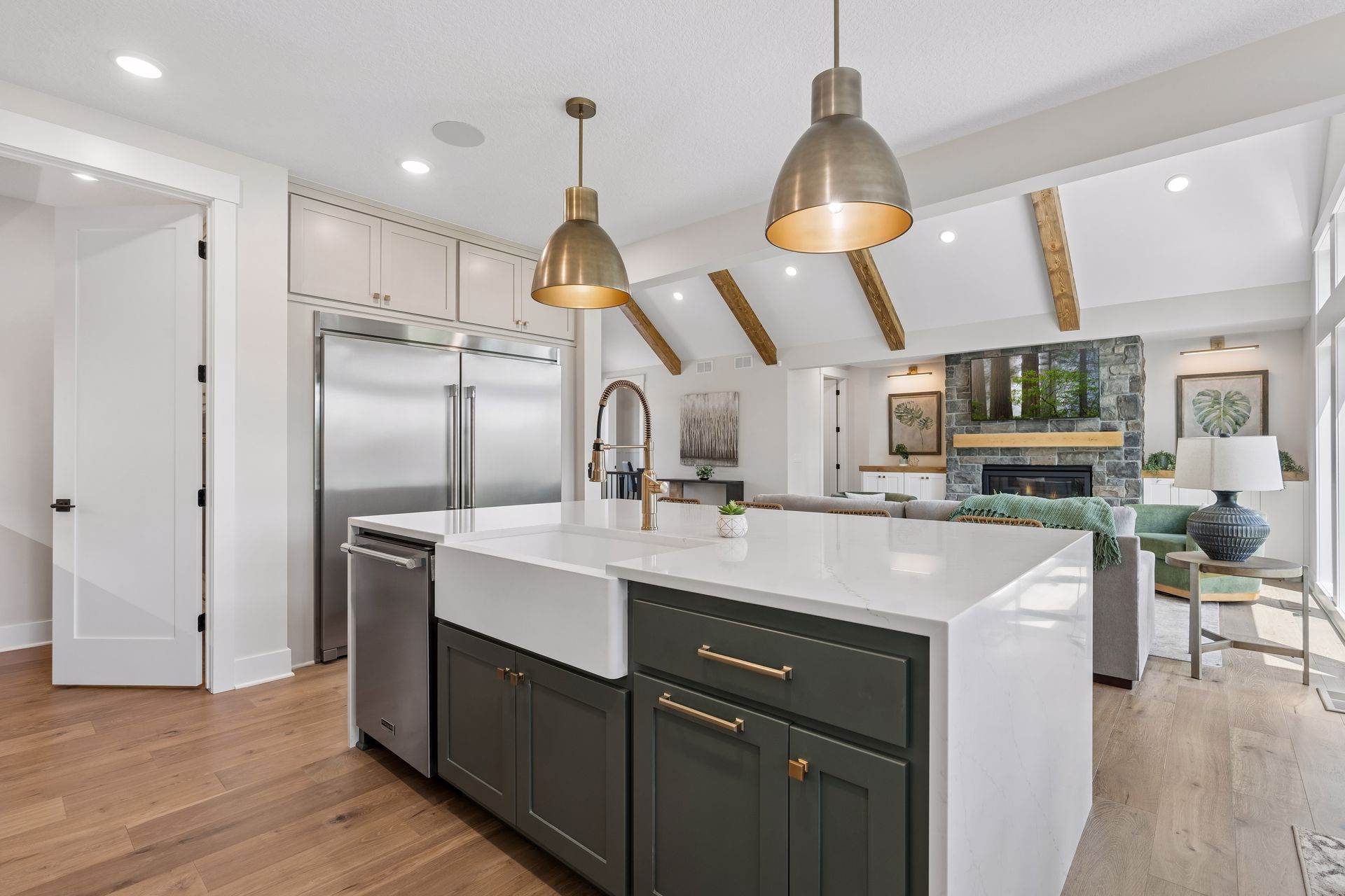 Kitchen island overlooking great room with vaulted ceilings and fireplace